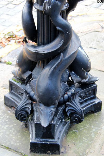 Dolphins adorn street lamp pole on Lime Street. Liverpool, England.