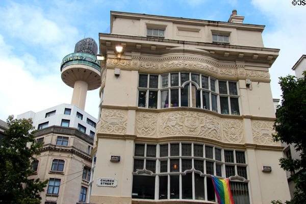 Bow fronted building with frieze (69 Church St.) with radio tower beyond. Liverpool, England.