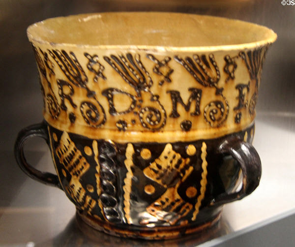 Glazed earthenware cup with slip decoration (1680-1700) prob. from Staffordshire at Walker Art Gallery. Liverpool, England.