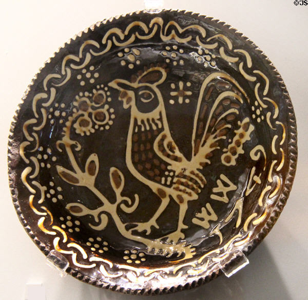 Glazed earthenware plate with slip rooster decoration (1749) prob. from Staffordshire at Walker Art Gallery. Liverpool, England.