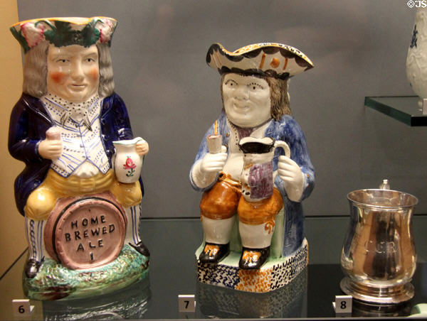 Earthenware Toby Fillpot jugs, one with drinker on barrel (c1830-40) & one drinker holding its own small jug (c1800) at Walker Art Gallery. Liverpool, England.