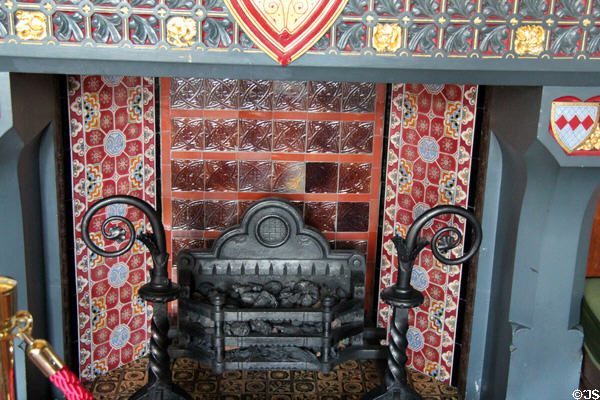 Tiles & grate of Love Conquers All chimneypiece in Winter Smoking Room at Cardiff Castle. Cardiff, Wales.