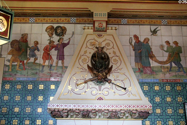 Chimneypiece & part of processional tiled frieze (1879) depicting heroes & heroines from children's literature painted by Horatio Lonsdale to designs of William Burges in Day Nursery at Cardiff Castle. Cardiff, Wales.