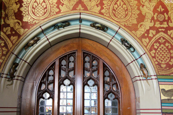 Archway over door with inset carvings of amphibians in Library at Cardiff Castle. Cardiff, Wales.