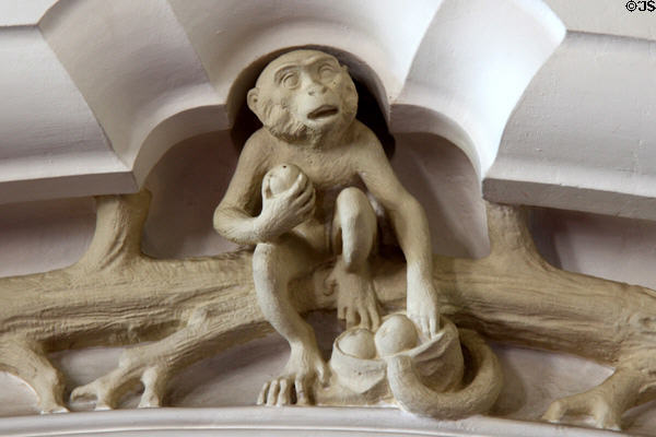 Sculpture of monkey holding fruit from Tree of Knowledge (in reference to Darwin) in Library at Cardiff Castle. Cardiff, Wales.