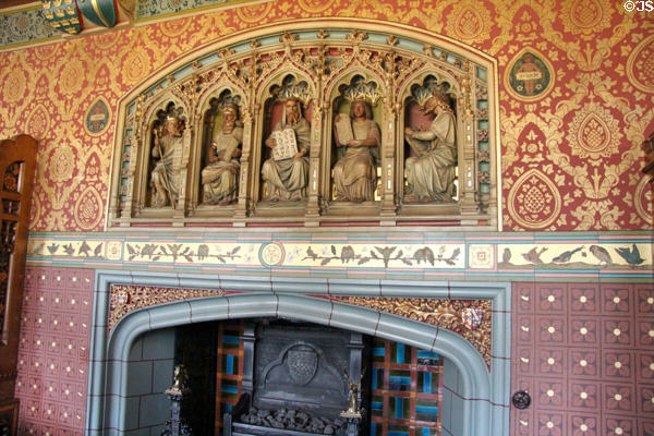 Carved figures holding scrolls in the five ancient languages on chimney piece in Library at Cardiff Castle. Cardiff, Wales.