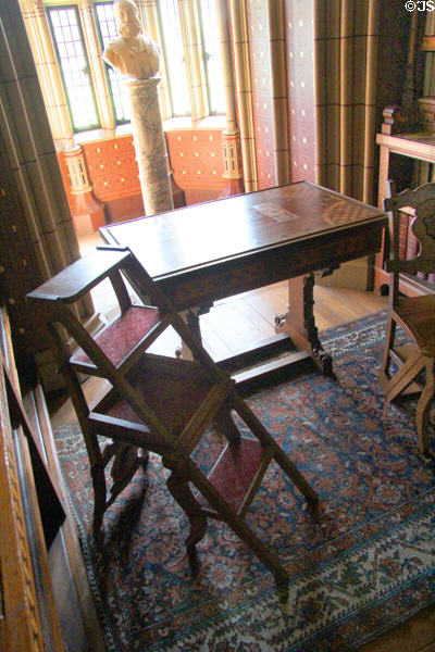 Library ladder & side table resting on oriental carpet in Library at Cardiff Castle. Cardiff, Wales.