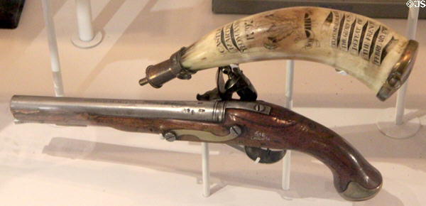 Holster pistol (1793) probably issued to King's Dragoon Guards & powder horn engraved with scrimshaw commemorating the surrender of French force which had landed in Wales in 1797 in Military Museum at Cardiff Castle. Cardiff, Wales.