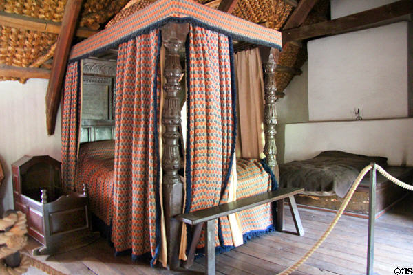 Carved wooden bed with curtains in Kennixton Farmhouse at St Fagans National Museum of History. Cardiff, Wales.