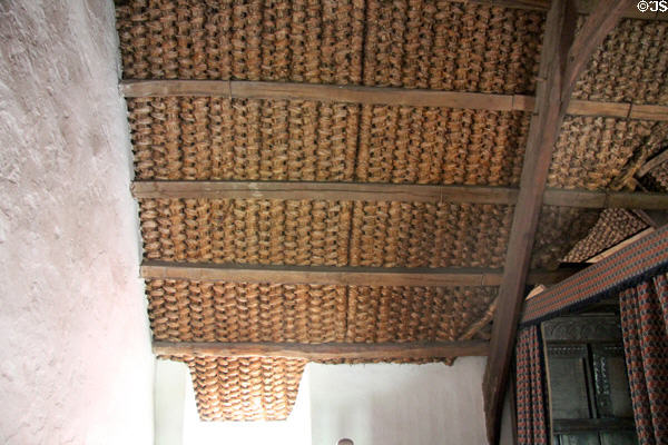 Straw mats lining upstairs ceiling which are tied to straw roof to keep it from blowing away in Kennixton Farmhouse at St Fagans National Museum of History. Cardiff, Wales.