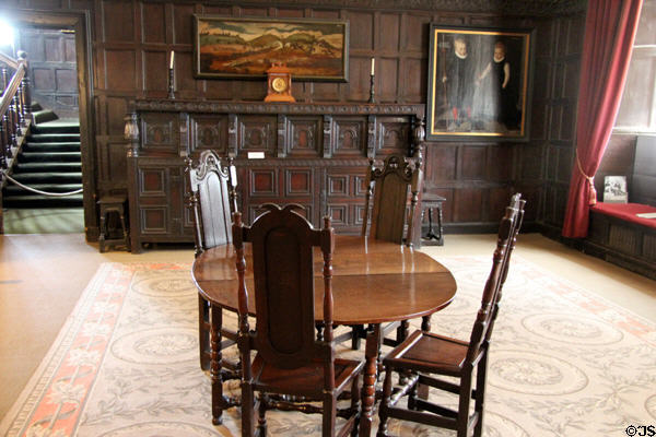 Interior room with round table surrounded by high back carved wood chairs in St Fagans Castle. Cardiff, Wales.