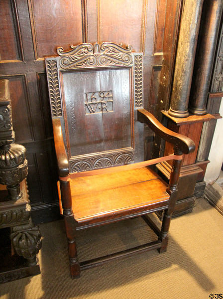 Great chair with date of 1694 carved on wooden back rest in St Fagans Castle. Cardiff, Wales.
