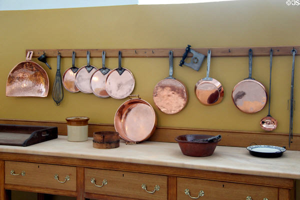 Copper colander, cooking pans & serving dish on display in kitchen at St Fagans Castle. Cardiff, Wales.