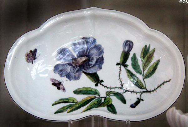 Soft-paste porcelain salad dish (c1755) with purple flower & stem made in Chelsea at National Museum of Wales. Cardiff, Wales.