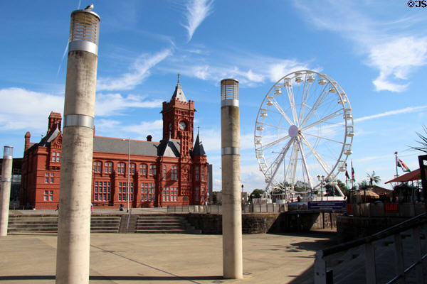 View of Pierhead building & Ferris wheel from water front at Cardiff Bay. Cardiff, Wales.