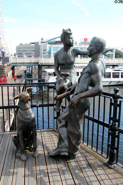 Bronze statue, "People Like Us" of man, woman & dog by John Clinch at Cardiff Bay. Cardiff, Wales.