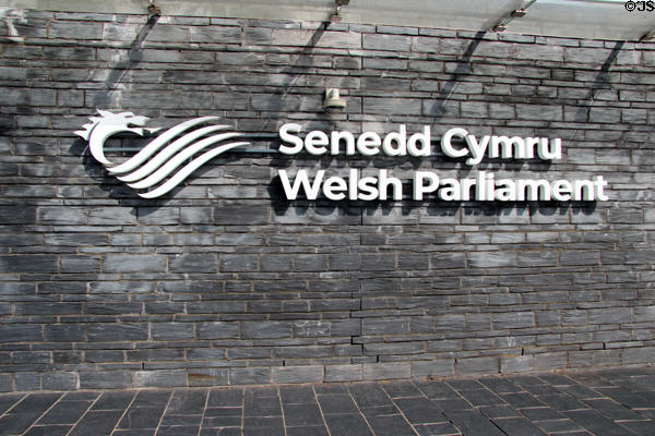 Sign for Senedd Cymru (aka Welsh Parliament) with dragon, the symbol of Wales, at Cardiff Bay. Cardiff, Wales.