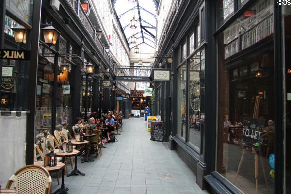 Shops & restaurants in glass roofed Castle Arcade building in City Centre. Cardiff, Wales.