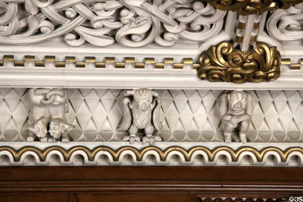 Sculpted plaster fantasy figures along frieze molding between wall & ceiling in Library at Penrhyn Castle. Bangor, Wales.