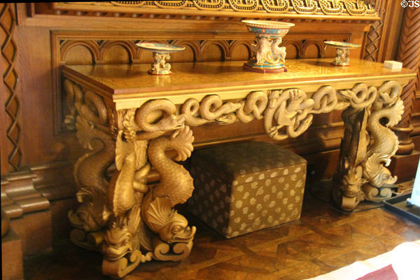 Wall table with ornately sculpted mythical beasts on front in Drawing Room at Penrhyn Castle. Bangor, Wales.