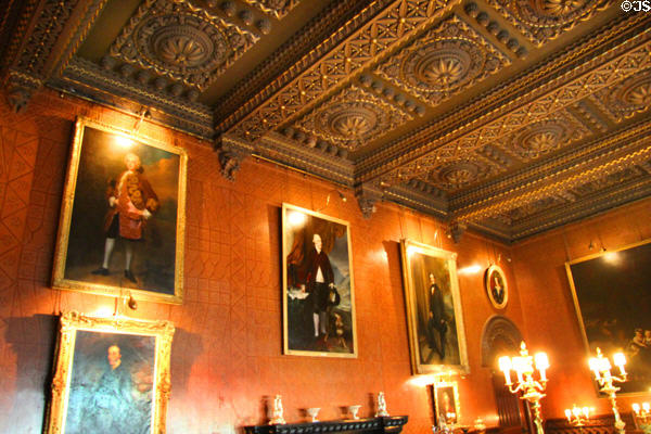 Paintings & ornate coffered ceiling in dining room at Penrhyn Castle. Bangor, Wales.