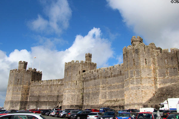 Immense walls, designed to withstand assault, at Caernarfon Castle. Caernarfon, Wales.