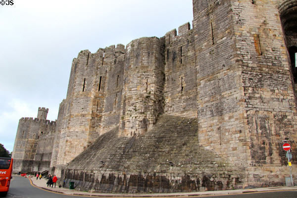 Massive walls & towers at Caernarfon Castle. Caernarfon, Wales.