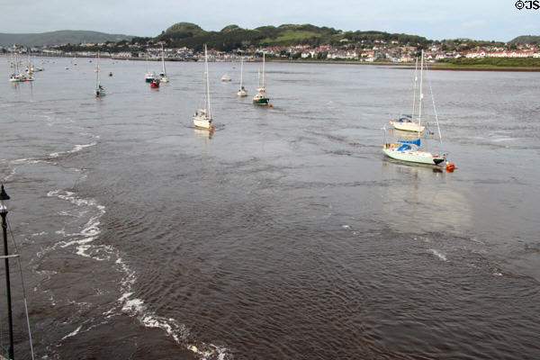 Boats anchored in Conwy harbor, part of the Conwy River leading to the Irish Sea. Conwy, Wales.