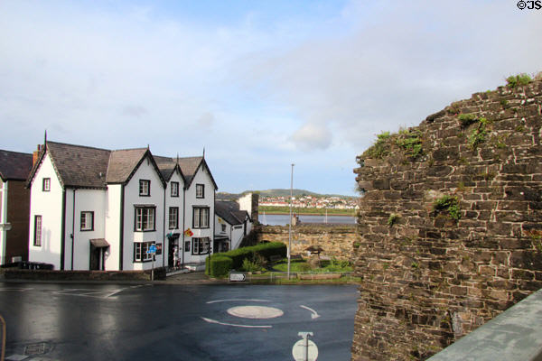 Ancient wall & building around traffic circle. Conwy, Wales.