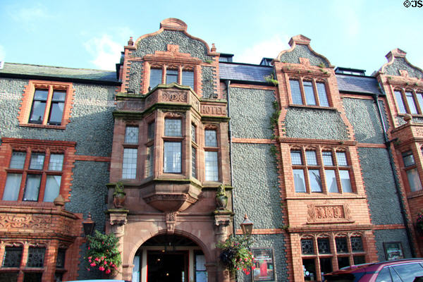 Castle Hotel (complete rebuilding 1885) on High St. with facade composed of small broken pieces of limestone. Conwy, Wales. Style: Renaissance. Architect: Douglas & Fordham.