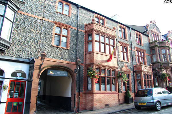 Castle Hotel on High St with detailed view of broken limestone facade. Conwy, Wales.