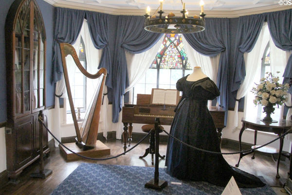 Black dress representing the "Two Ladies" era & Triple String harp (1840) at Plas Newydd. Llangollen, Wales.