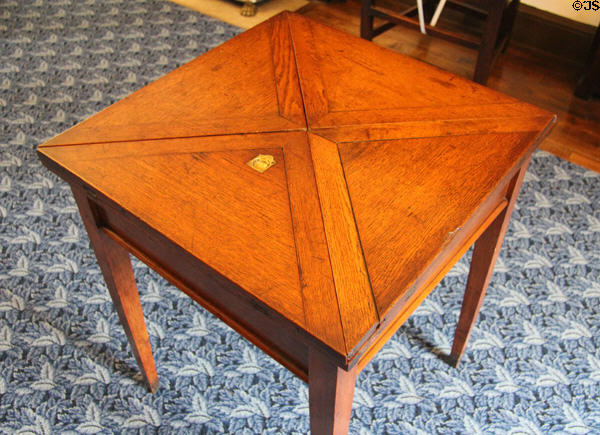 Light oak card table which can be enlarged by opening triangular flaps at Plas Newydd. Llangollen, Wales.