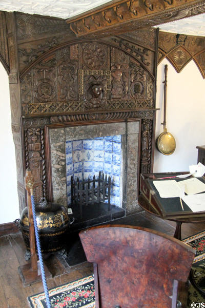 Fireplace with carved wood surround & Delft tile backing at Plas Newydd. Llangollen, Wales.