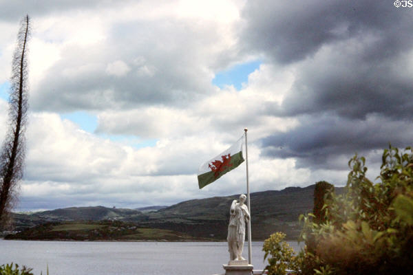 View from Portmeirion Village with Welsh flag in foreground. Gwynedd, Wales.