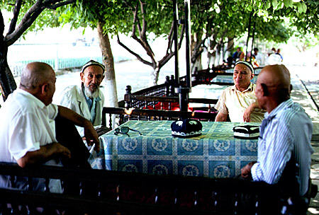 Men sit at tables in the Bazaar of Samarkand. Uzbekistan.