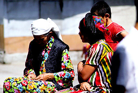 Colorful dresses of women in Samarkand market. Uzbekistan.