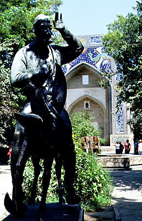 Statue in front of Bukhara's Divan Begi of wise man who agreed to teach his donkey to talk. Uzbekistan.