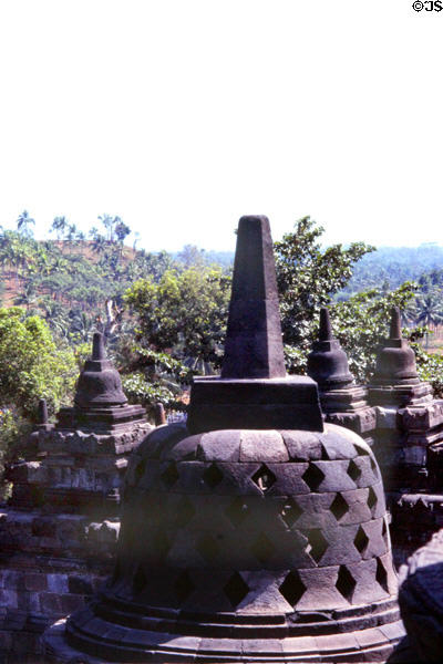 Lawu Volcano in distance on the island of Java seen against Borobudur stupas. Indonesia.