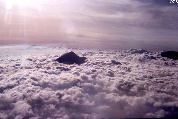 Volcanoes on the island of Java poke through the clouds. Indonesia.