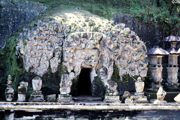 Carved rocks over entrance to a temple in a cave called Goa Gajah. Bali, Indonesia.