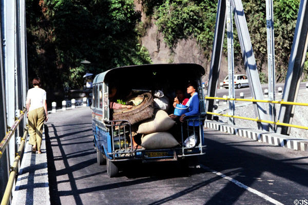 Jitney carrying crops across bridge. Bali, Indonesia.