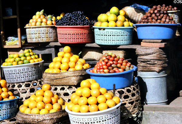 Citrus fruits & brown salak fruit at street stand. Bali, Indonesia.