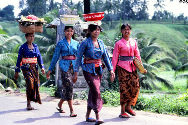 Women carrying goods on their heads in traditional manner. Bali, Indonesia.