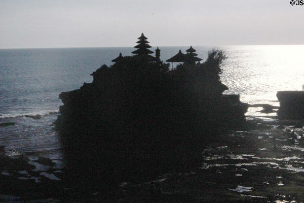 Tanah Lot temple silhouetted against the sea. Bali, Indonesia.