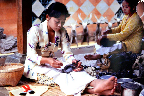 Woman working on a wood carving. Bali, Indonesia.
