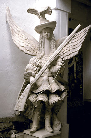 Long-necked Angel with gun in Taller Hilario Mendivil Museum, Cusco. Peru.