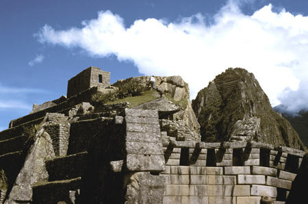 Main temple (sliding apart), observatory hill with Intihuatana, Huayna Picchu at Machu Picchu. Peru.