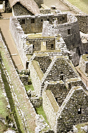 View down to curved Temple of the Sun, Machu Picchu. Peru.