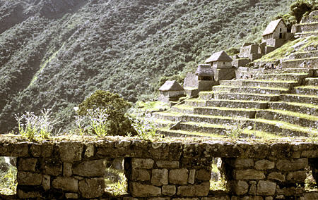 Wall at Condor Temple, Machu Picchu & warehouse buildings of agricultural section. Peru.